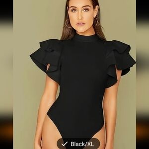 Gorgeous black knit bodysuit with layers of fabric pieces for sleeves. Snap clos